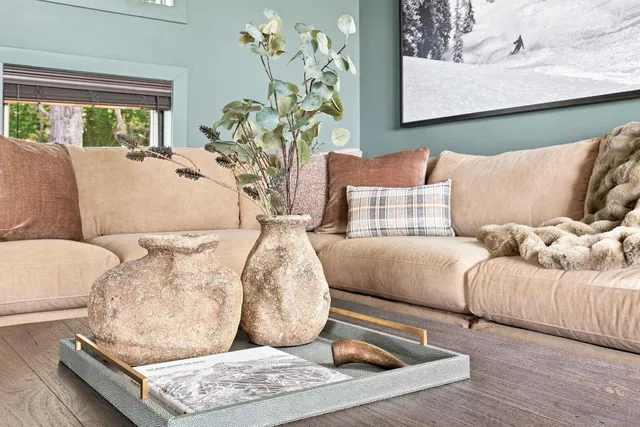 Styled coffee table vignette with stoneware vases and dried stems on a shagreen tray