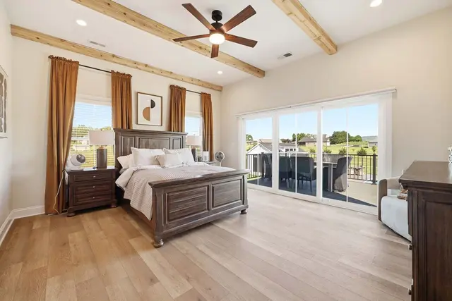 Interior bedroom photography  -  master suite with wood beams and balcony